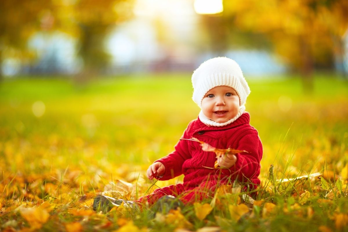baby outdoors in the fallen leaves