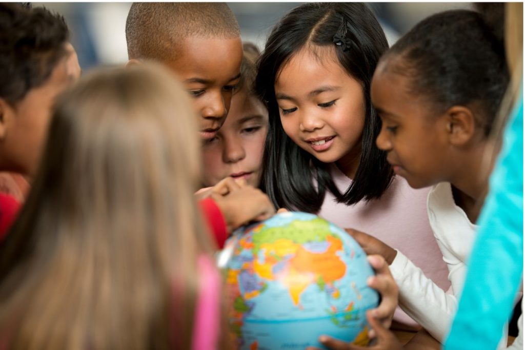 children looking at globe school.jpg